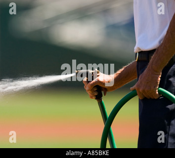 Man watering a lawn Stock Photo