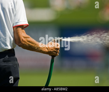 Man watering a lawn Stock Photo