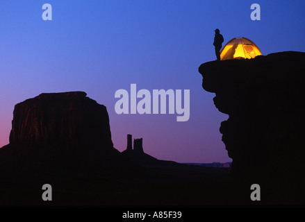 Camper enjoys the view from his campsite on a cliff overlooking Monument Valley Arizona - Utah Stock Photo