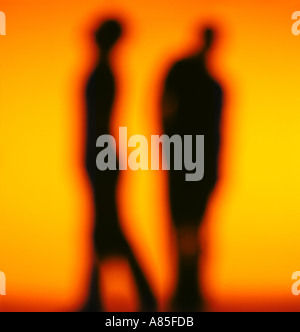 SILHOUETTE OF TWO PERSONS TALKING Stock Photo