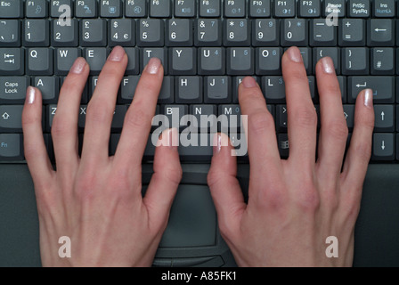Close Up of a Caucasian Woman Typing on the Keyboard of a Laptop Computer Stock Photo