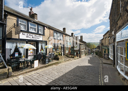 Shops and Ye Olde Bronte Tea Rooms on the main street in the village centre, Haworth, West Yorkshire, England, UK Stock Photo