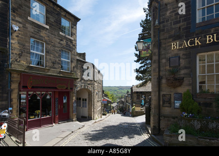 Shops and Black Bull Public House on the main street in the village centre, Haworth, West Yorkshire, England, UK Stock Photo