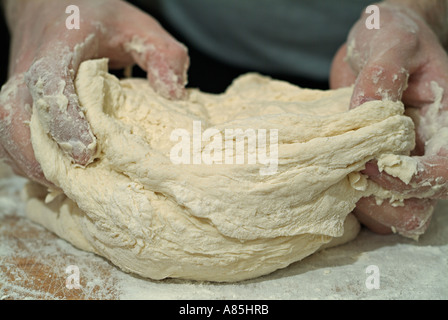 Baker Kneading Bread Dough Stock Photo