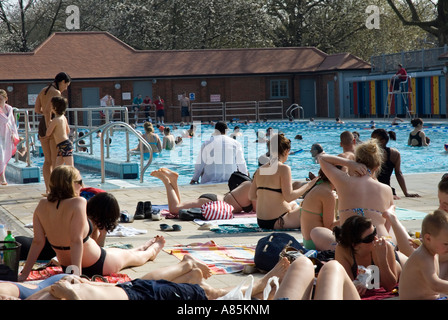 People enjoying sunny afternoon London Fields LIDO London Borough of Hackney outdoor swimming pool Stock Photo