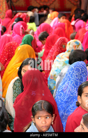 Women dressed in colourful sarees attending a religious ceremony in Pushkar, Rajasthan, India. Stock Photo