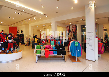 Entrance no doors interior of United Colors of Benetton fashion clothing retail business store from pavement Oxford Circus West End London England UK Stock Photo