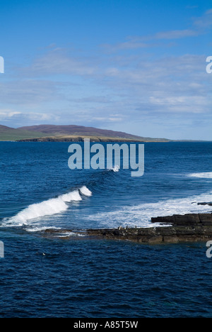 dh Eynhallow Sound EVIE ORKNEY Rolling waves ashore seacliff rocks blue sea and Rousay island coast
