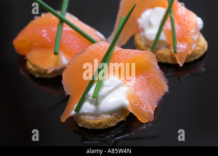 Smoked salmon canapes on a black plate. Stock Photo