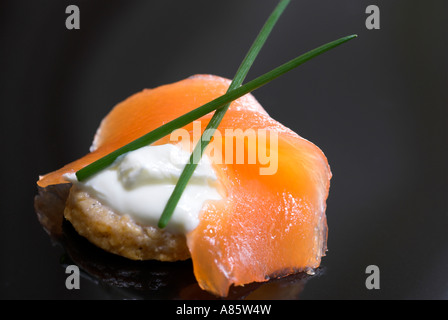 Smoked salmon canapes on a black plate. Stock Photo