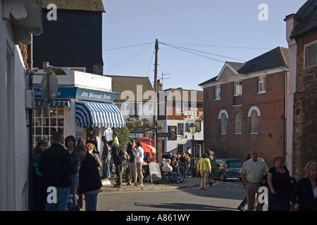 Mermaid Street and The Strand Rye on a Saturday morning people walking and congregating beside public  houses The Ship Inn and Old Borough Arms, Rye, Stock Photo