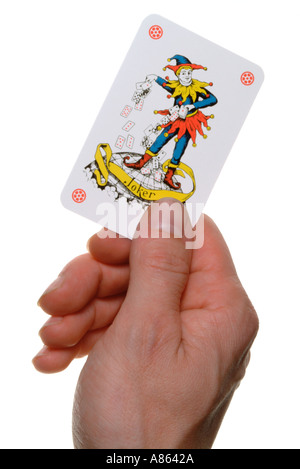 mans hand holding a joker playing card Stock Photo