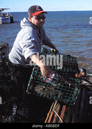 Micmac Fish Fishermen throwing lobster trap Stock Photo - Alamy