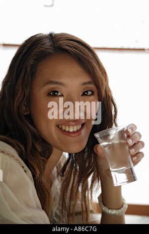 Young woman drinking, portrait Stock Photo