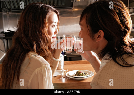 Young couple holding glass, rear view Stock Photo