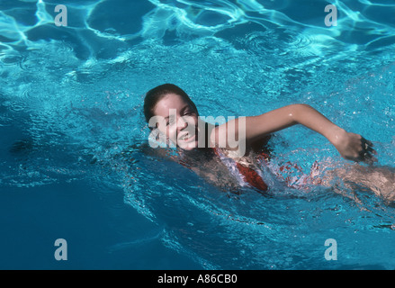 attractive young woman swimming in pool Stock Photo