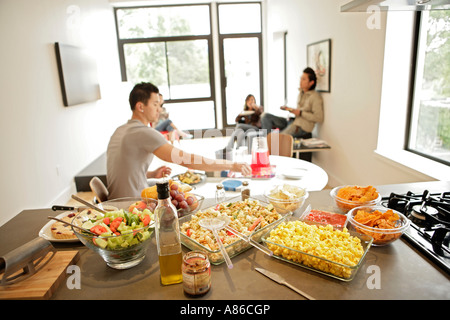 Four people having their meal, side view Stock Photo