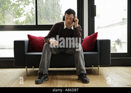 A young man listening music with head phones Stock Photo