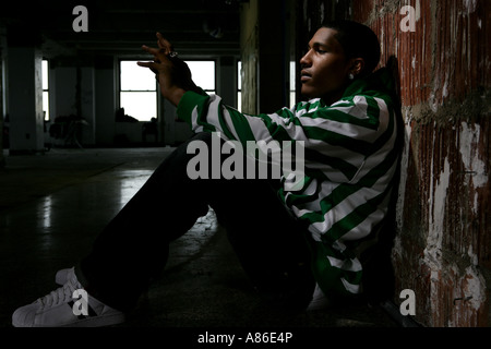 Young man sitting on the floor Stock Photo