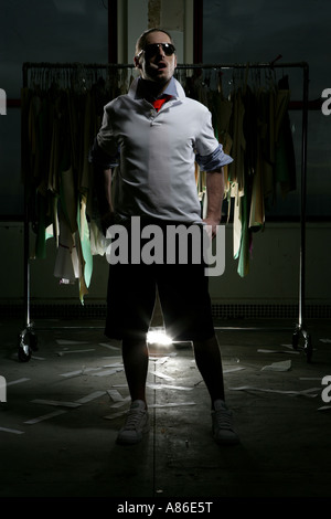 Man wearing shades with his hands in his pockets Stock Photo