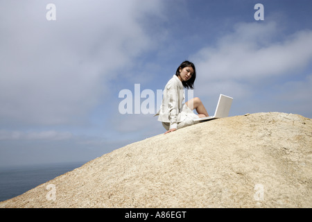 View of a woman working on a laptop. Stock Photo