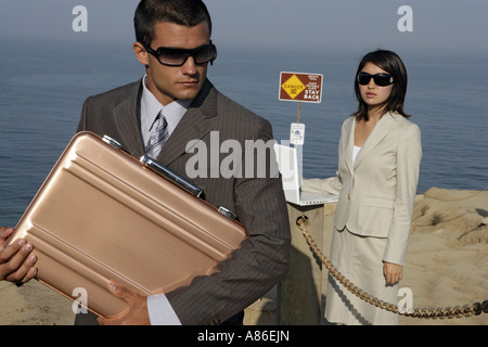 View of a man and a woman standing near a sea. Stock Photo