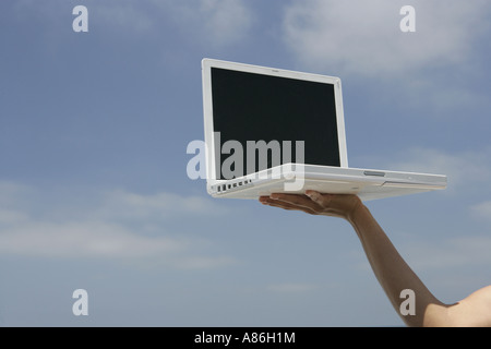 View of a laptop held up high. Stock Photo