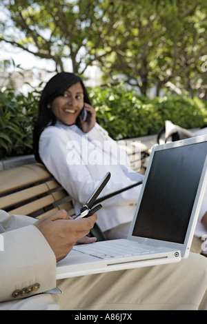 View of two colleagues using electronic devices. Stock Photo