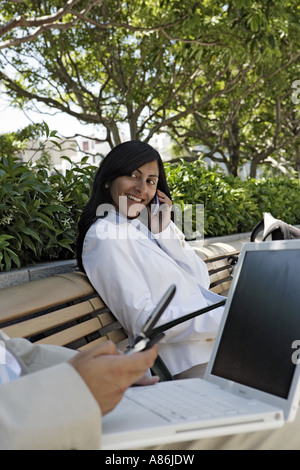 View of two colleagues using electronic devices. Stock Photo