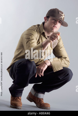 young handsome male model poses in baseball cap and casual clothes a86k46