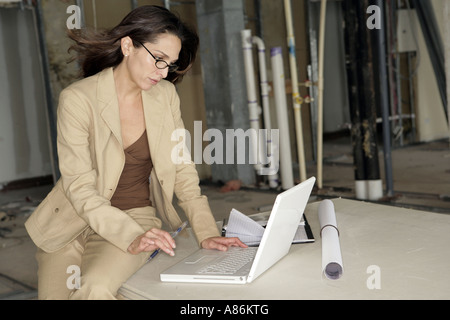 View of businesswoman working on a laptop. Stock Photo