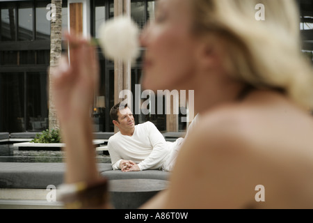 View of a woman smelling a rose. Stock Photo