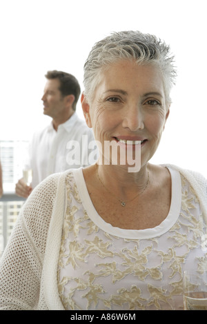Mature woman with a short hair cut looking at camera Stock Photo