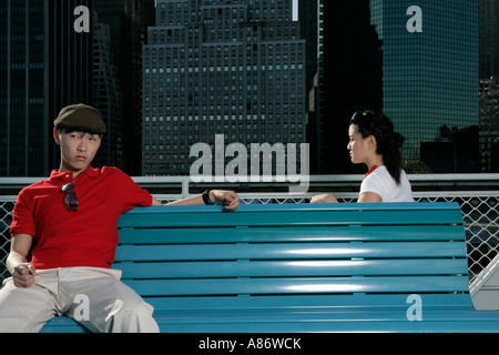 Two people sitting on benches Stock Photo