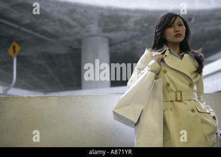 A woman is standing with her shopping bags. Stock Photo