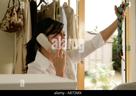 Woman talking on the phone, side view Stock Photo
