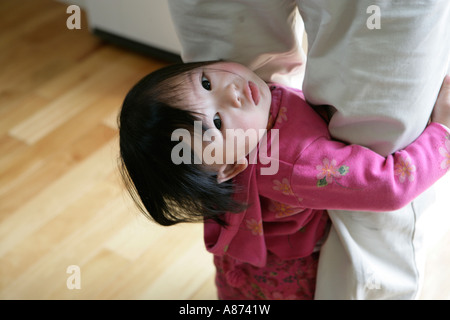 Child holding mother's feet, elevated view Stock Photo