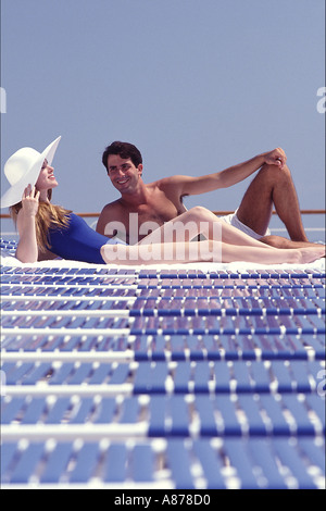Couple resting on beach chairs. Stock Photo