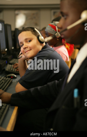Boy (11-13) sitting by computer, portrait Stock Photo