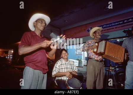 Musical group playing cumbia on the street at night in Cartagena Colombia Stock Photo