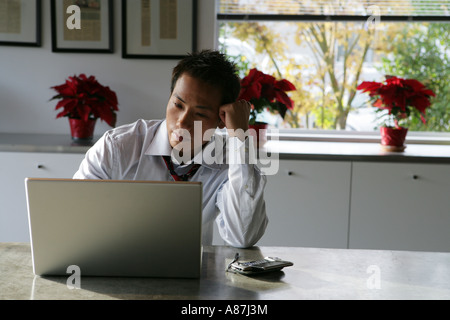 Young man using a laptop computer Stock Photo