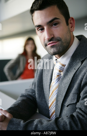 Two people looking at camera, woman out of focus Stock Photo