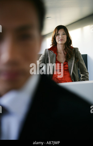 Two people looking at camera, one man out of focus Stock Photo