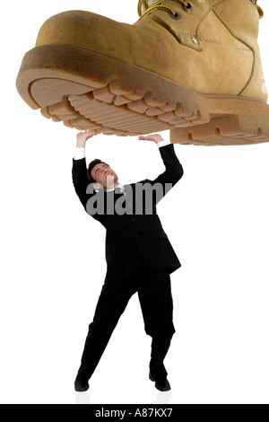 businessman being stepped on under pressure Stock Photo