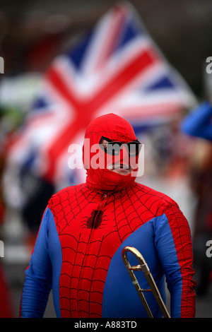 Clowns and a marching band of Spidermen march thorugh the town of Bognor Regis in the UK Stock Photo