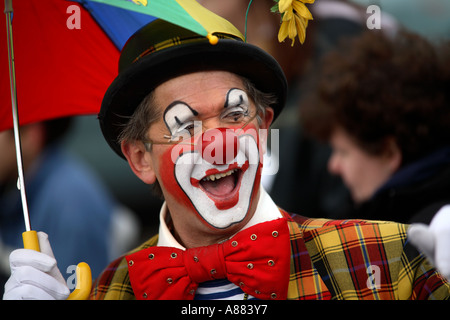 Clowns and a marching band of Spidermen march thorugh the town of Bognor Regis in the UK Stock Photo