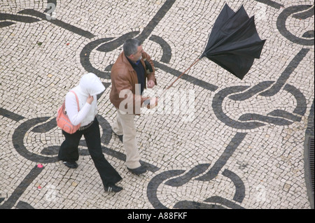 a mans umbrella is blown inside out by strong winds in Aveiro, portugal Stock Photo