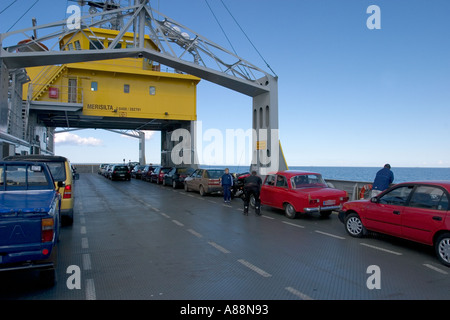 People and cars at sea in a small ferryboat going to Hailuoto Island Finland Stock Photo