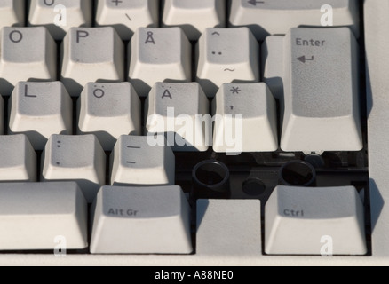 Broken Scandinavian computer keyboard which has missing keys Stock Photo