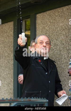 Priest Sprinkling Holy Water while giving a blessing Stock Photo